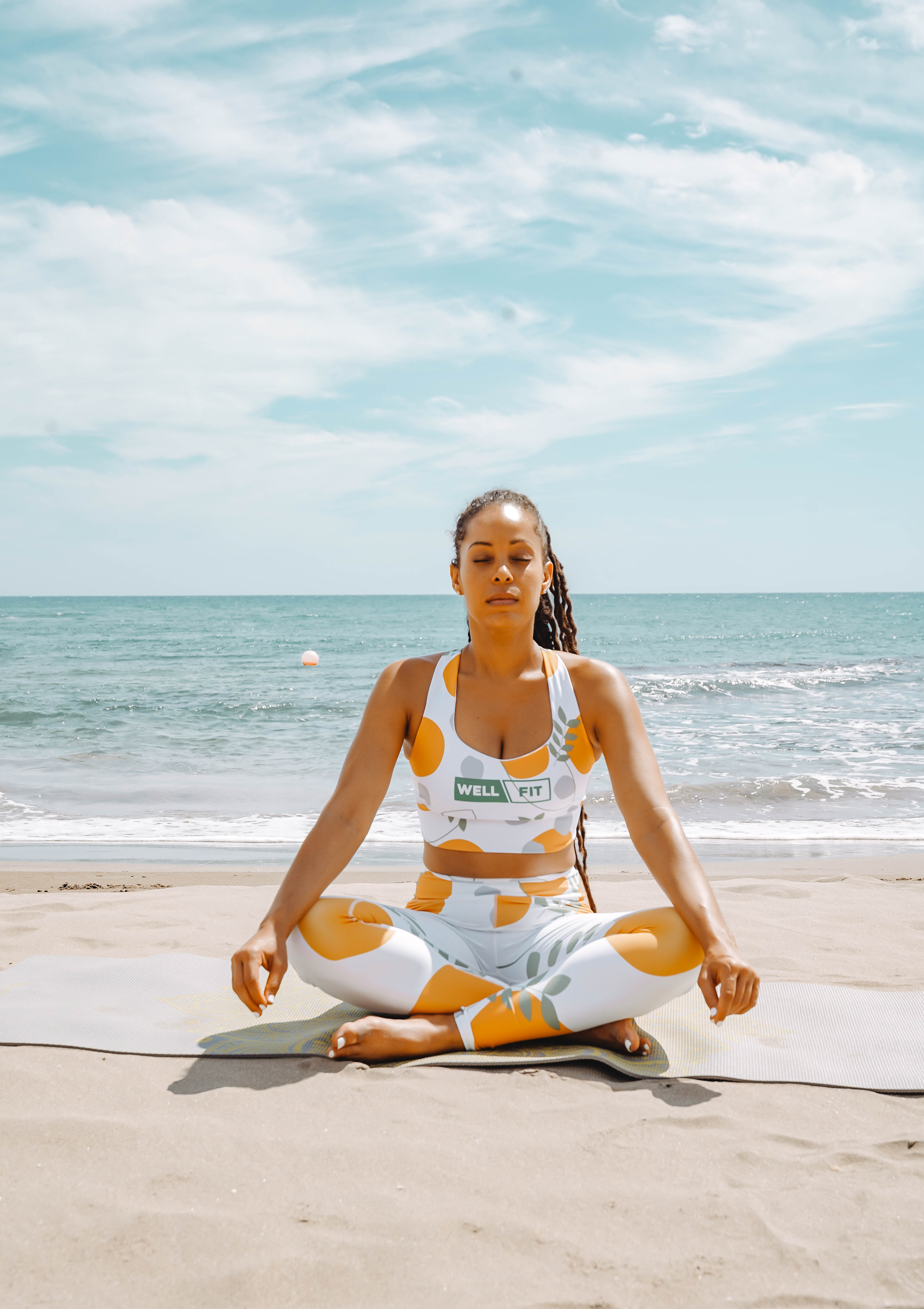 Woman meditating on the beach